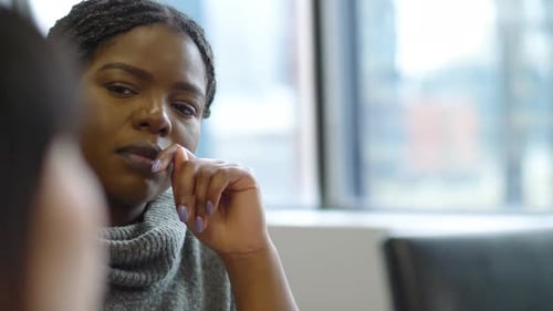 Attentive businesswomen listen during a corporate meeting in the office