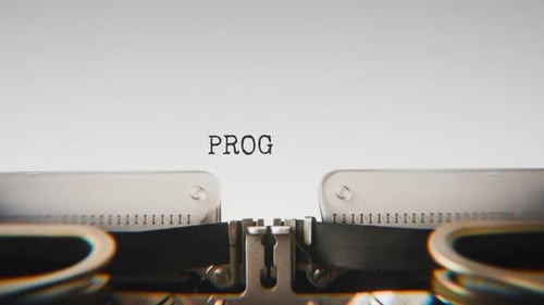 Old mechanical typewriter typing Progress in a close-up view.