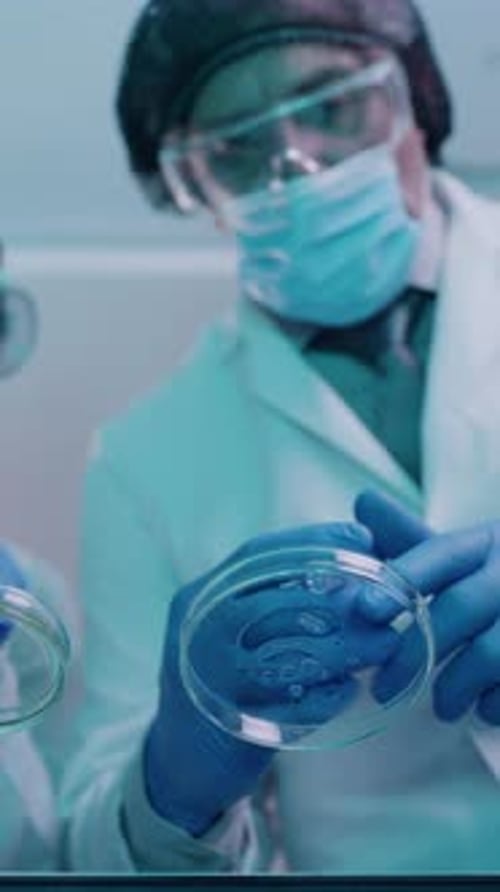 Medical workers with petri dish in a lab