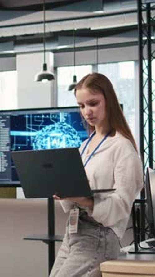 Vertical Video Portrait of Young Smiling Female Programmer in Office Automating with AI