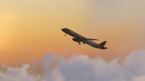 Commercial Airplane Taking Off Against Golden Sunset Sky