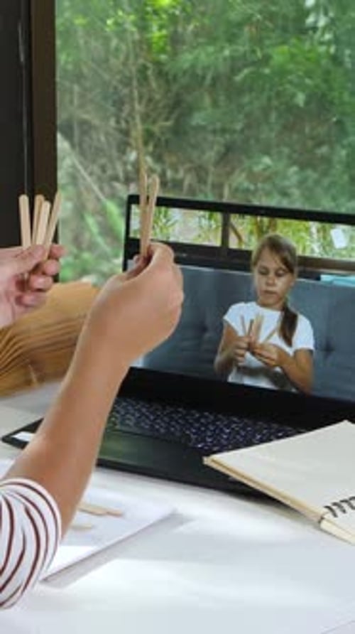 Little School Girl Learns Math and Counting Through Online Lessons