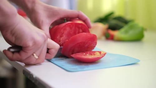 Chop Tomato Close Up Diced Tomatoes on a Cutting Board for Italian Sauce Man Cut Tomatoes with Knife