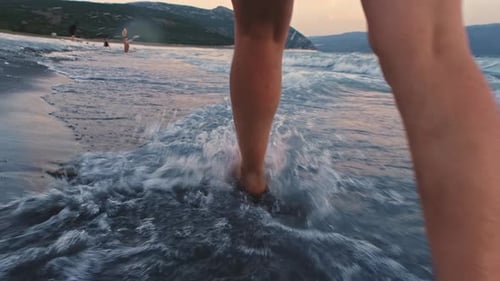 Bare Feet Walking On The Beach