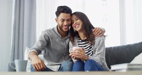 Happy Couple Smiling Together on Living Room Couch