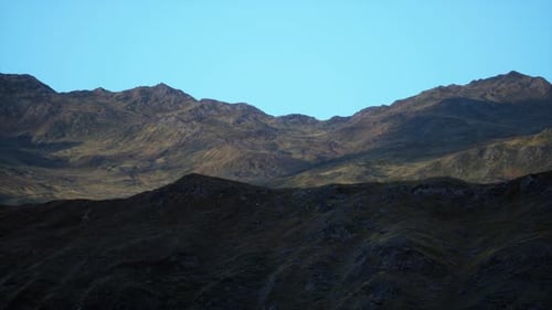 A Mountain Range with a Blue Sky in the Background