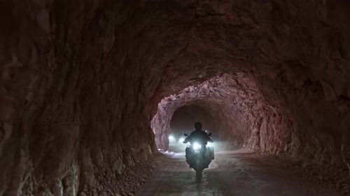 Motorcycle Convoy Riding Inside Rock Tunnel in Dark Canyon, Turkey