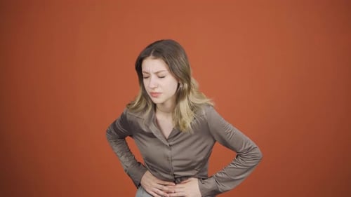 Young woman experiencing stomachache.