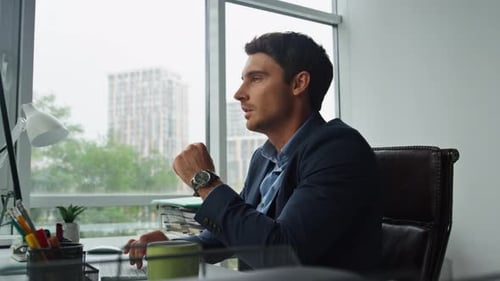 Office Worker Leaning Chair at Glass Workplace. Thoughtful Man Taking Break Resting