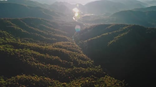 Sun Shining Over Forested Mountains and River in Chiang Mai Thailand