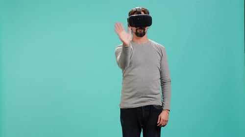 Man Using Virtual Reality Headset on Blue Background