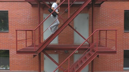 Businessman Climbing Up the Stairs of a Business Centre