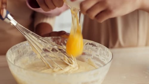 Mother and Daughter Baking Together in a Cozy Kitchen While Making Pastries
