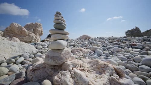 Close up of carefully balanced stones forming cairns on the beach near Aphrodite's Rock