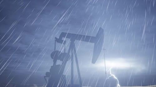 Pumpjack Working Through Rain In Dark Overcast Sky