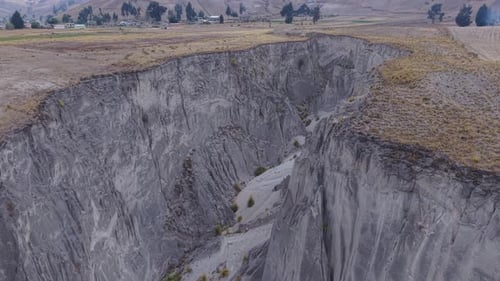 Aerial Panorama Revealing Steep Canyon Cutting Through Rugged Ecuadorian Terrain Small Village