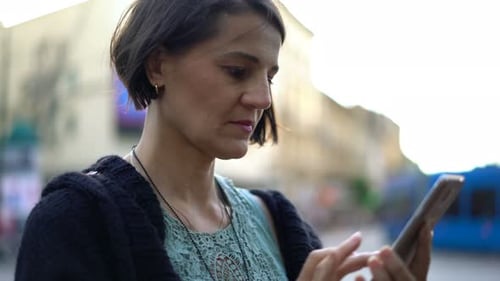 Young Woman Texting on Smartphone Standing in the City Adult