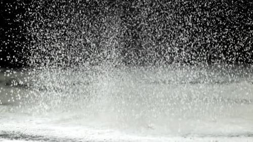 Flour Pouring on a Black Background