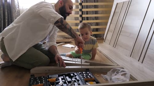 Father and Child Assembling Furniture Together at Home