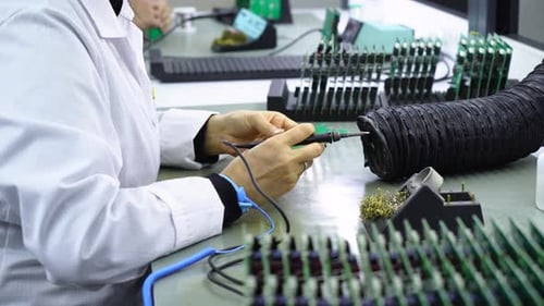 Soldering Components onto a Circuit Board in Factory