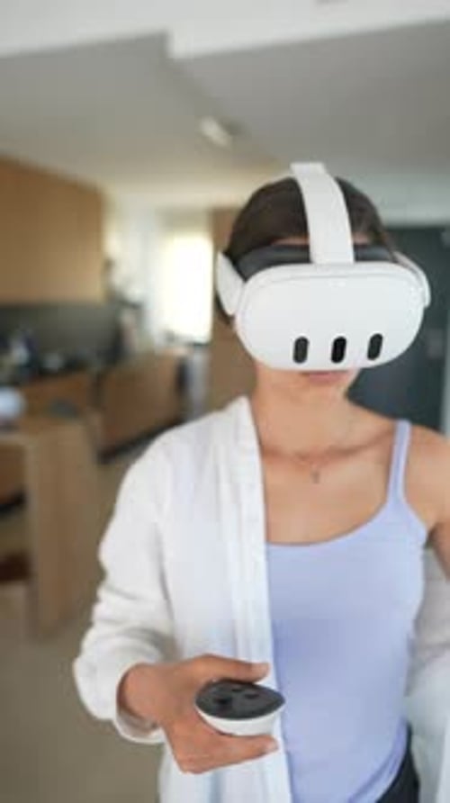Woman Wearing VR Headset Using Controllers Indoors