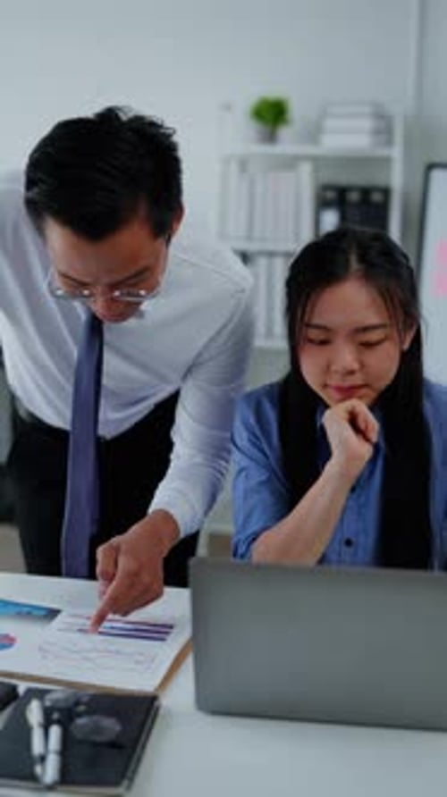 Professionals Discussing Data Report at Work