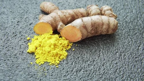 Fresh turmeric rhizome and powder. Yellow curcumin. Curcuma