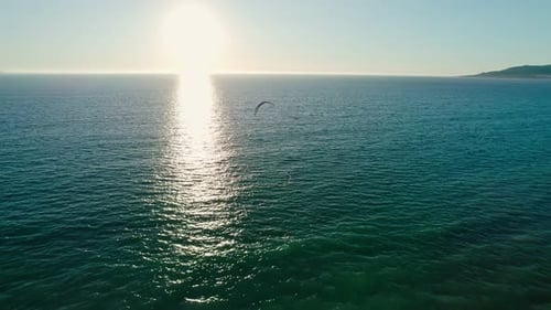 Kitesurfer Gliding on Ocean Waves Aerial View