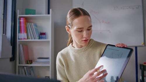 Woman Explaining Lesson on Tablet During Online Tutoring