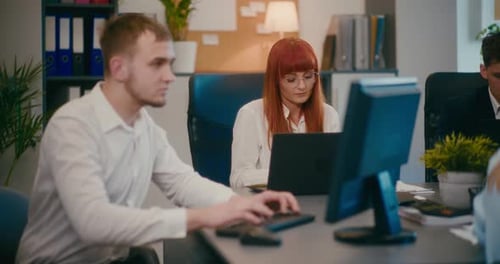 Businesswoman Working on Laptop at Desk in Office