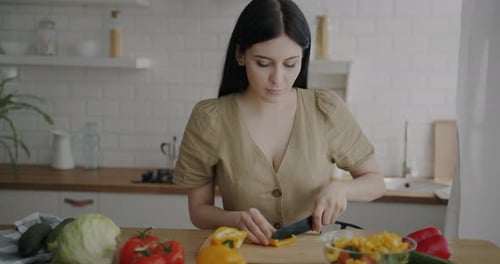 Woman Preparing Healthy Salad in Bright Kitchen