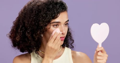 Makeup, sponge or woman in studio with mirror, coverage and puff in self care