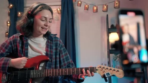 Close Up Shot of Portrait Cheerful Teenager Woman Playing Guitar While Sitting