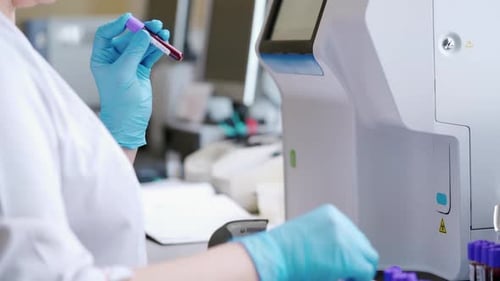 Lab Technician Handling Blood Samples in Laboratory