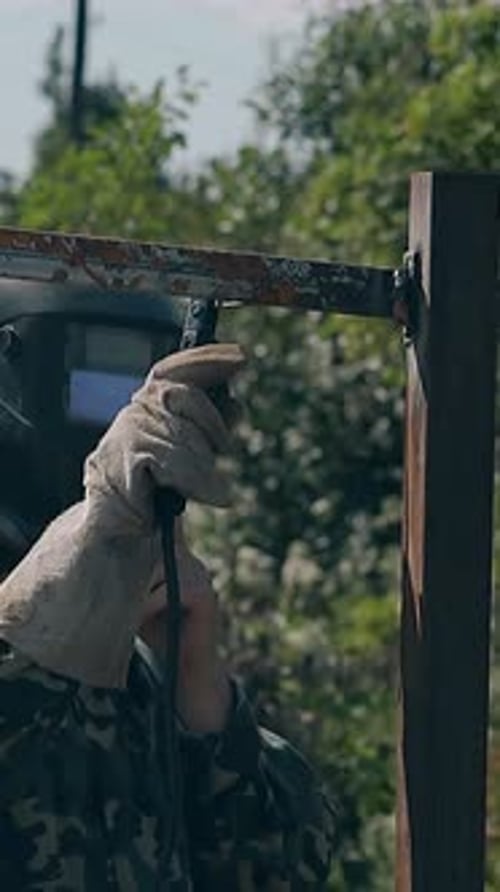 Slow Motion Welder Fixes Carcass of Fence at Country House