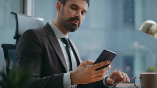Office Worker Typing Laptop Computer on Desk Looking Smartphone Screen Close Up
