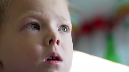 Young Boy with Blue Eyes Looking Upward