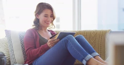 Woman Shopping Online with Tablet on Couch