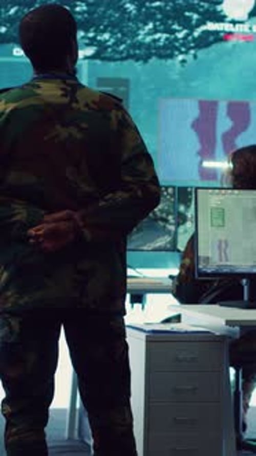 Military Personnel in Dark, Secure War Room