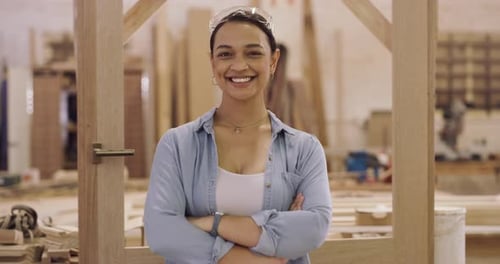 4k video footage of a young female construction worker in her wood workshop