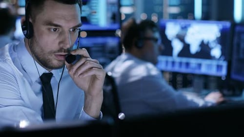 Man Talking on Headset in Control Center