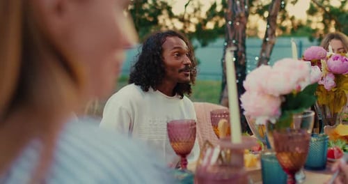 Friends Enjoying Outdoor Meal at Garden Party
