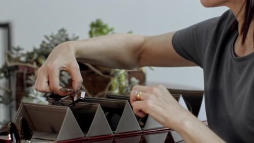 Adult Removing Glasses from a Storage Organizer
