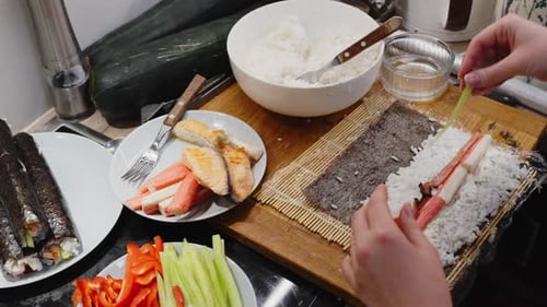 Woman making Japanese sushi rolls at home, Close up