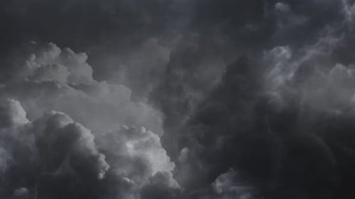 dark and moving cumulonimbus clouds and thunderstorm