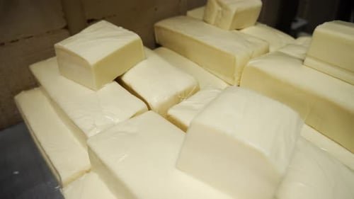 Stacked blocks of white cheese