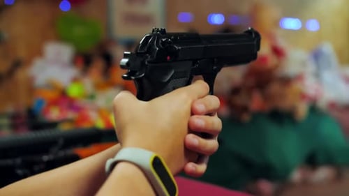 Ein junges Mädchen schießt mit einer Pistole auf einem Schießstand