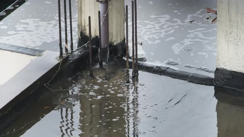 Water Flowing from Pipe onto Flooded Rooftop