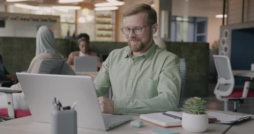 Man on Laptop in Modern Office