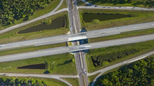 Freeway Overpass Junction with Fast Moving Traffic Cars and Trucks in American Rural Area Timelapse